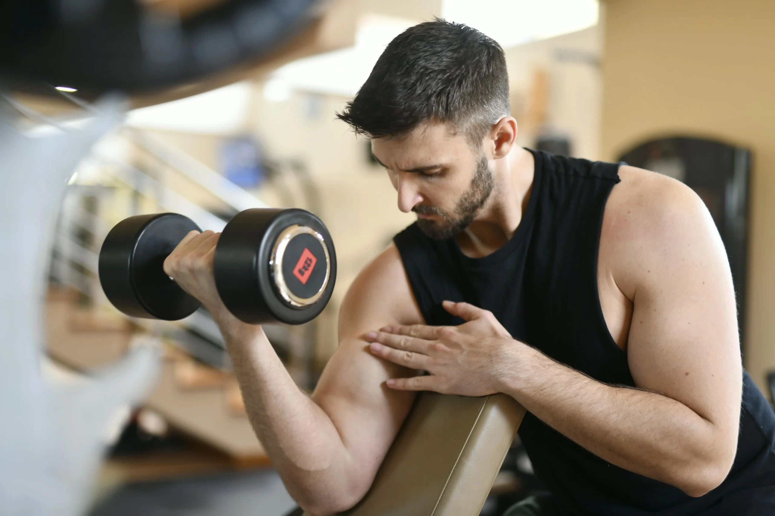 A man is lifting a weight at the gym.